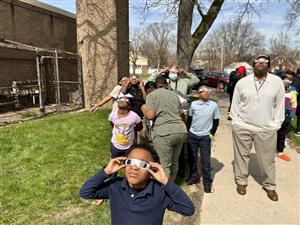 Students and staff looking at the Eclipse